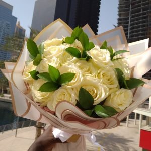 Bouquet of 24 white roses with greenery