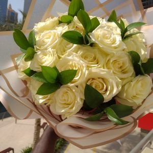 Bouquet of 24 white roses with greenery